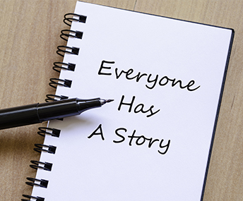 Everyone has a story written on a notepad with a pen